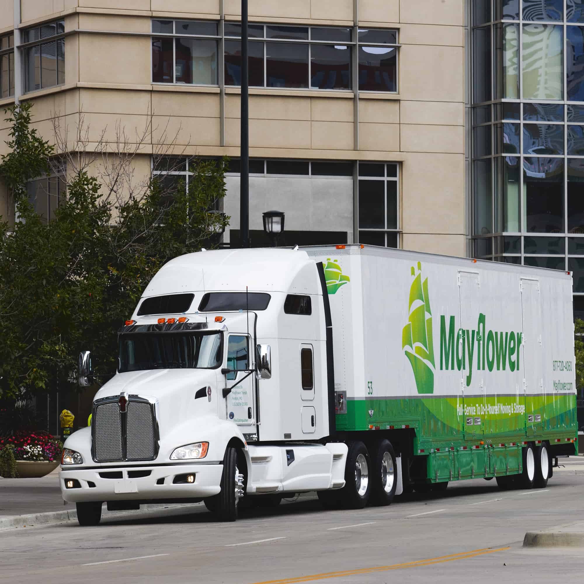 mayflower moving truck driving through downtown - Mayflower®