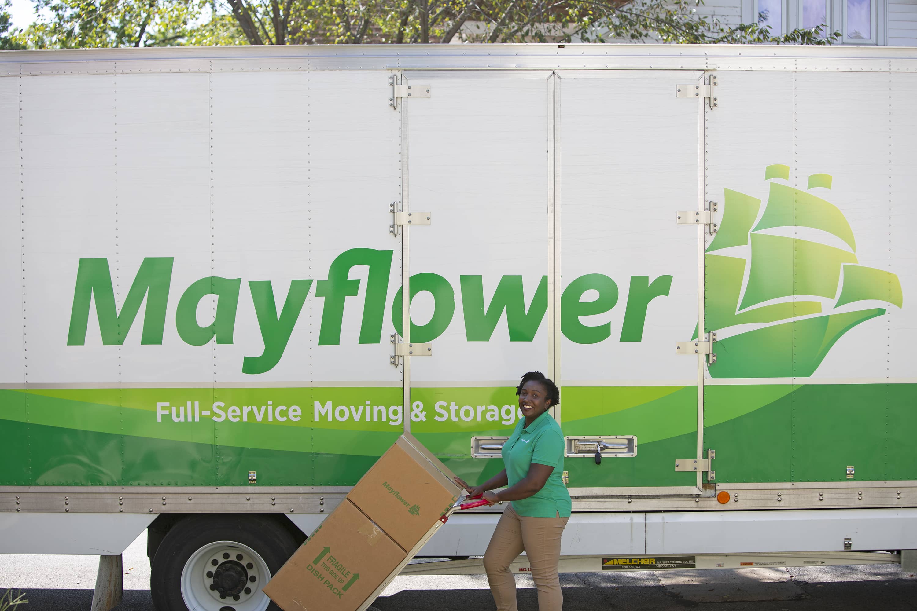 Estimate Your Moving Costs - Mayflower mover transporting moving boxes from a Mayflower moving truck - Mayflower