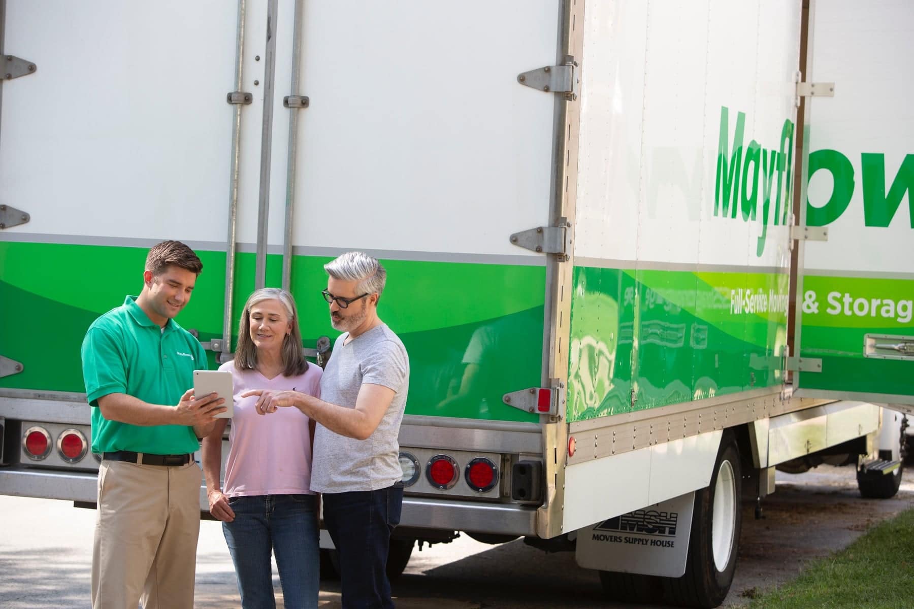 mover speaking with a couple outside in front of a moving truck - Mayflower®