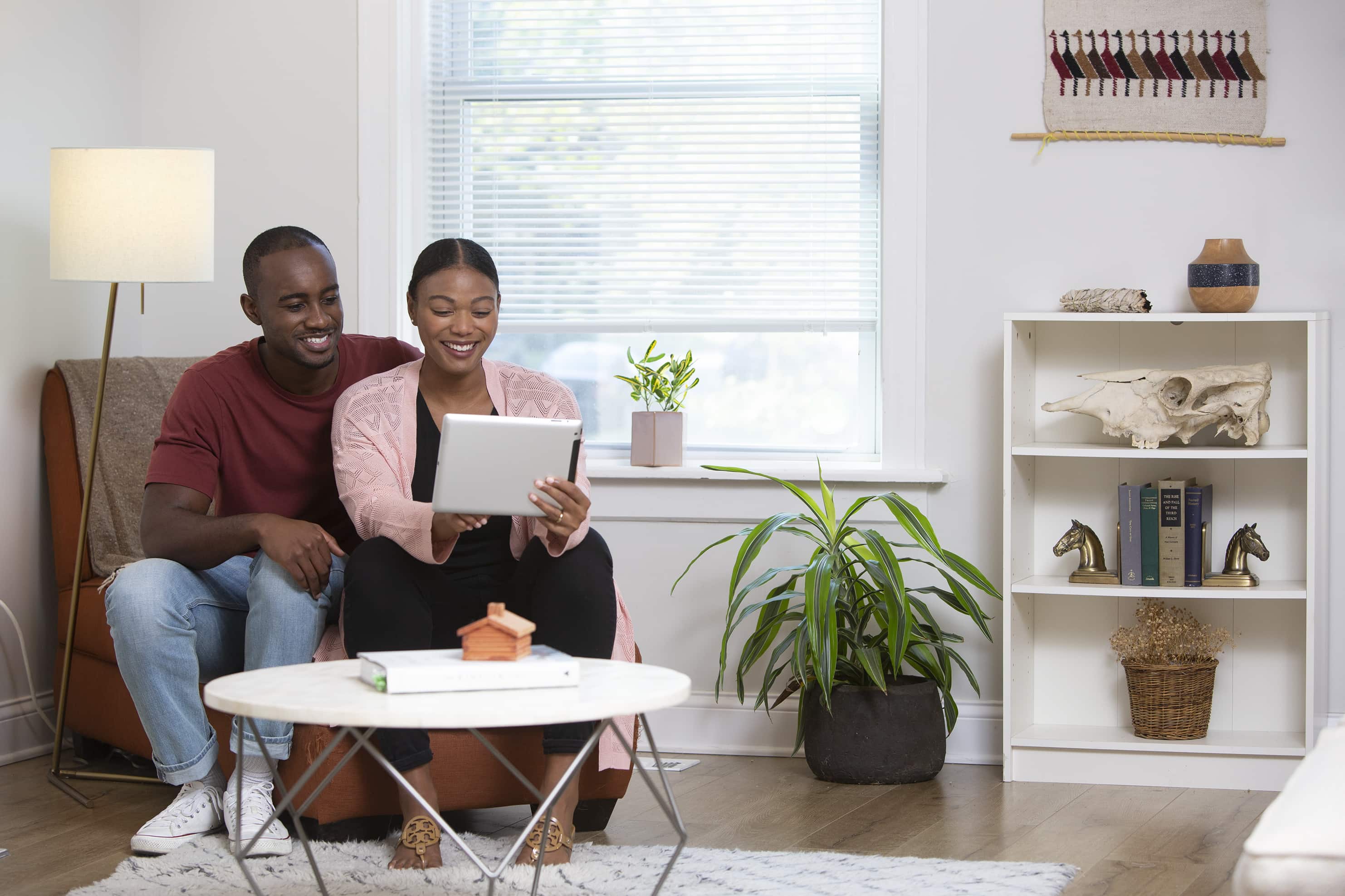 a couple holding a tablet in their living room - Mayflower®