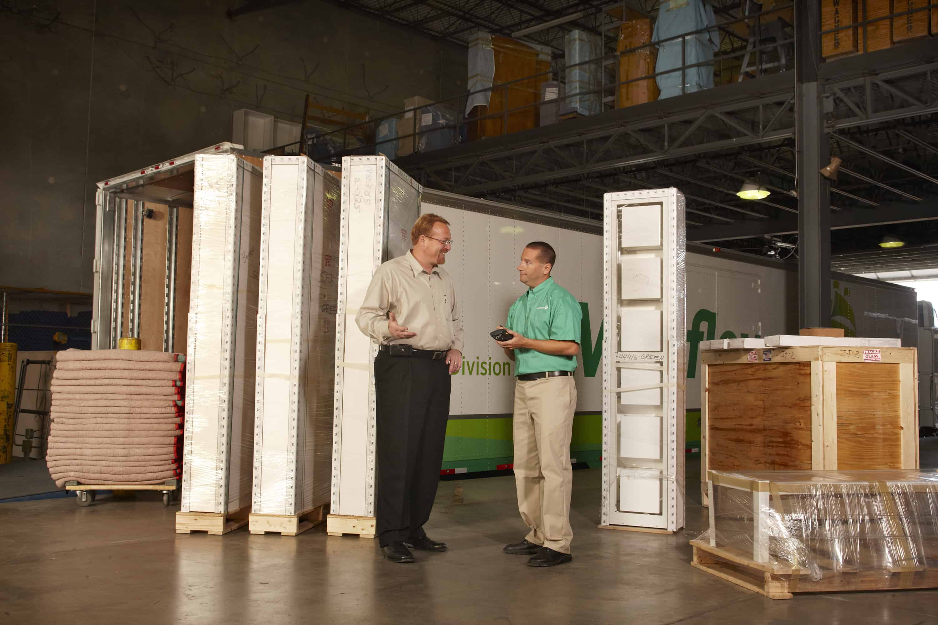 Mayflower worker with a retail customer in the warehouse reviewing a shipment - Mayflower®
