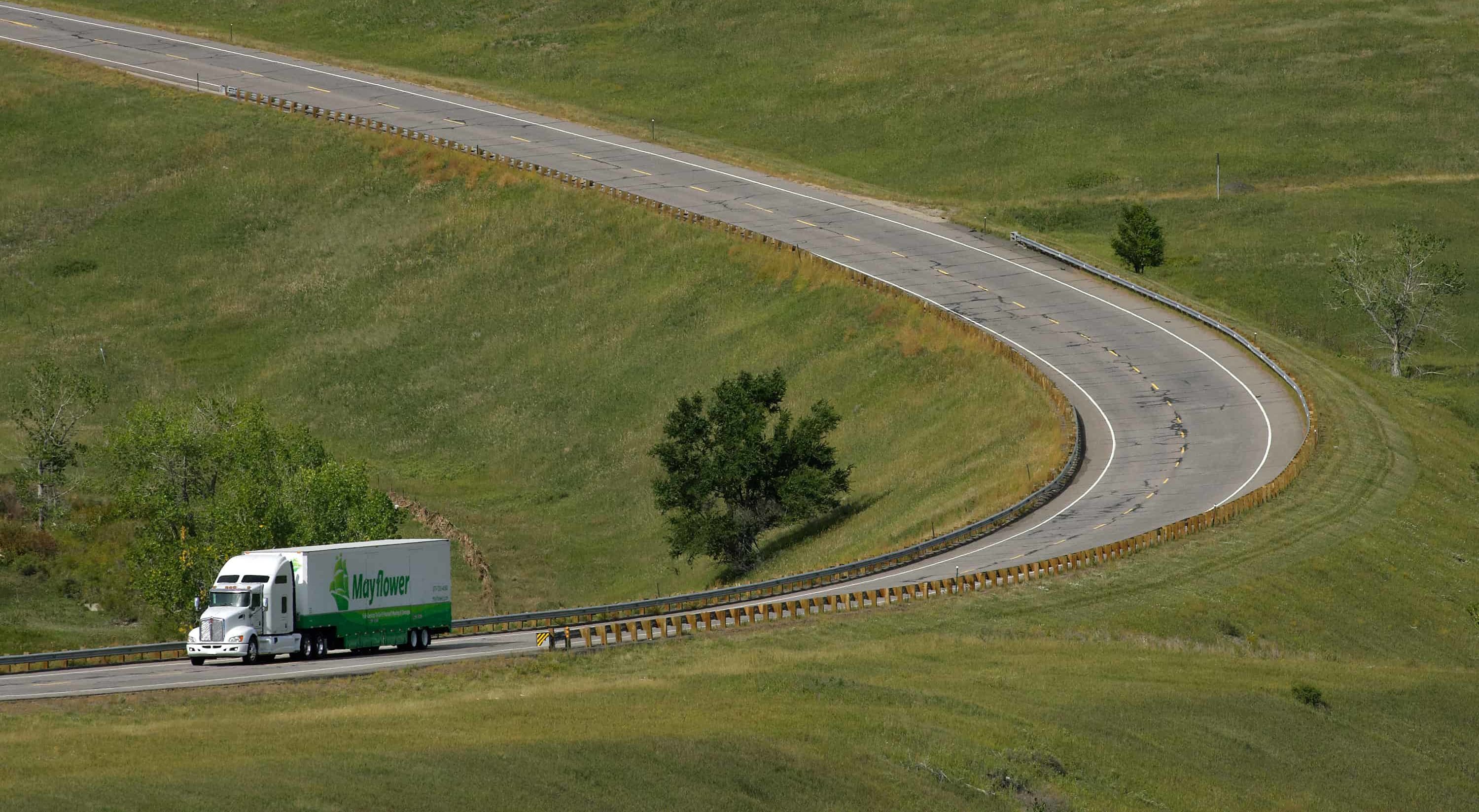 Mayflower moving truck drivind down a mountain road - Mayflower®