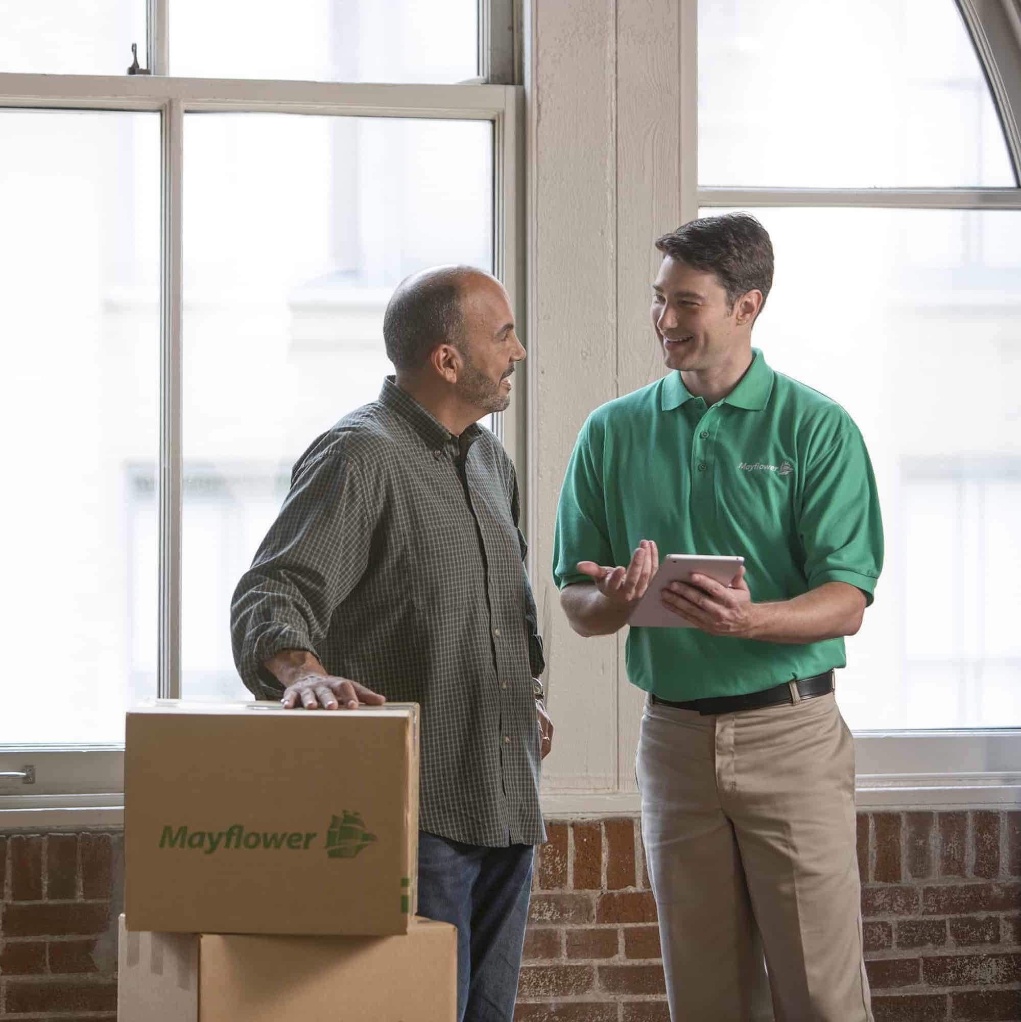 mayflower mover working with customer in his home in front of moving boxes - Mayflower®